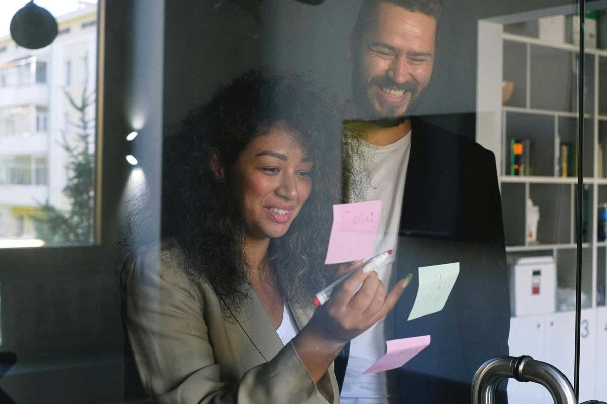 Dos personas analizando post its